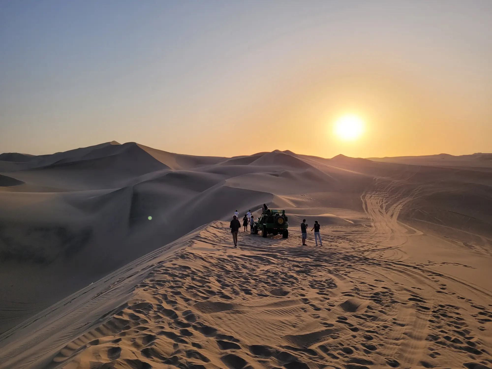 Sunset over sand dunes near Paracas