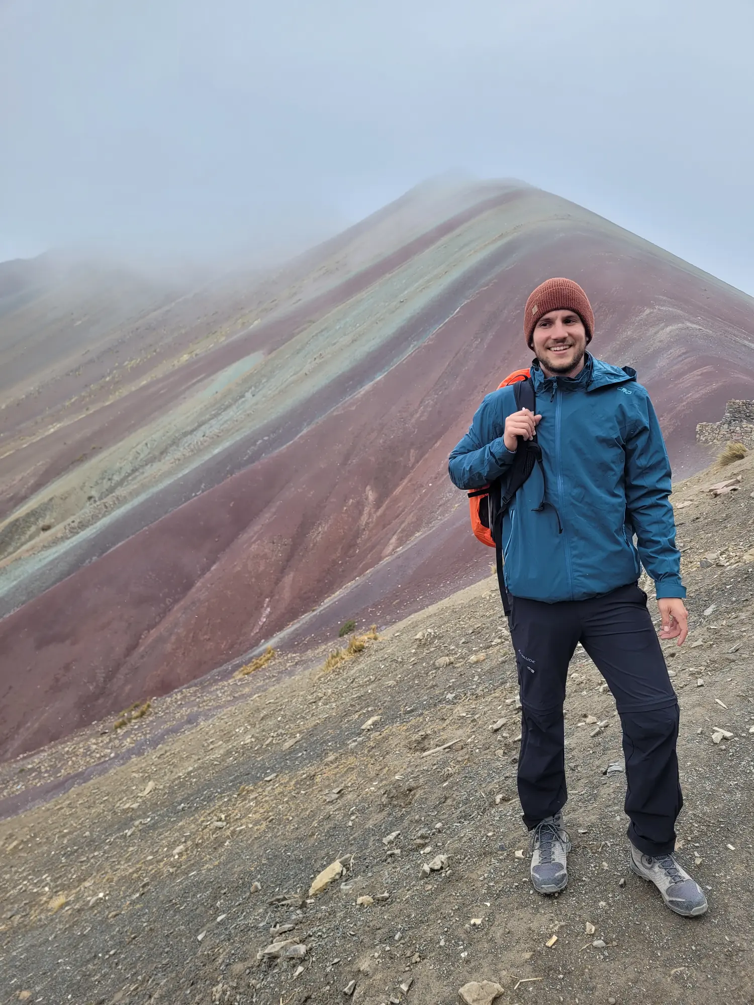 Standing in front of Rainbow Mountain in Peru