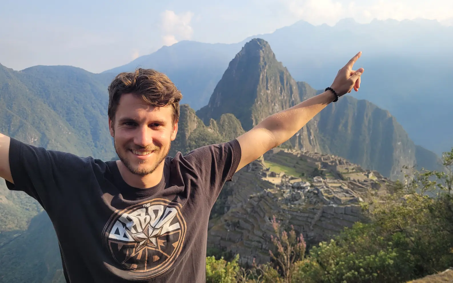 Standing in front of Machu Picchu with the mountain scenery behind me.