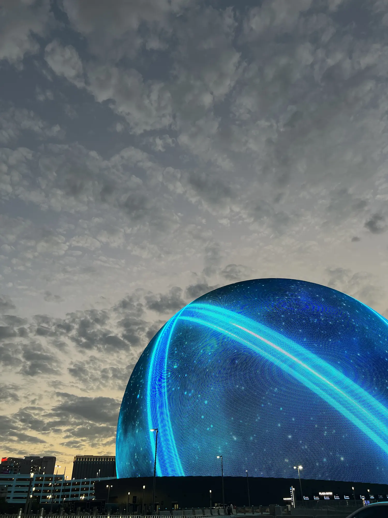 The Las Vegas Sphere glowing blue at night
