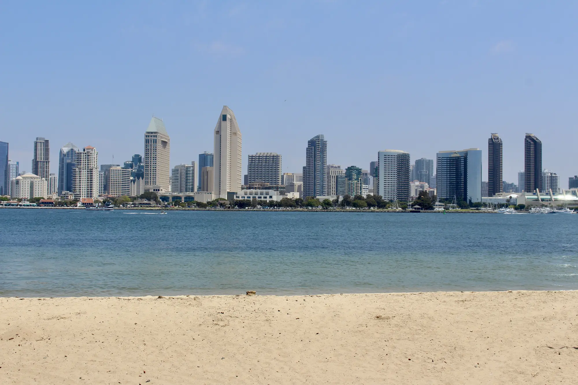 San Diego skyline viewed across the water from a sandy beach